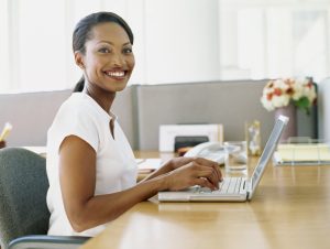 side profile of a businesswoman using a laptop
